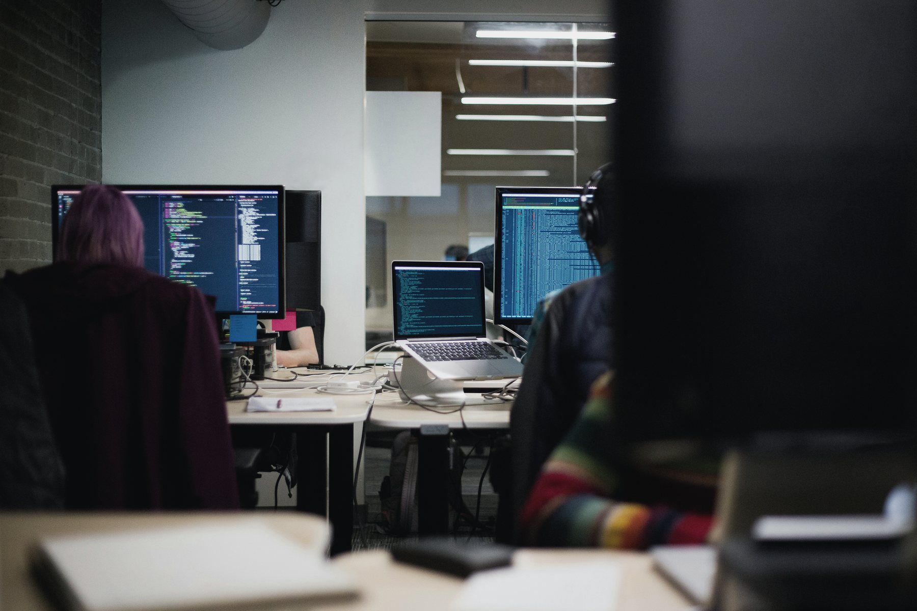 Engineers working across adjacent workstations